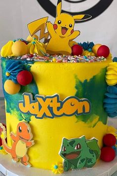 a pokemon themed birthday cake with pikachu and other characters on the frosting