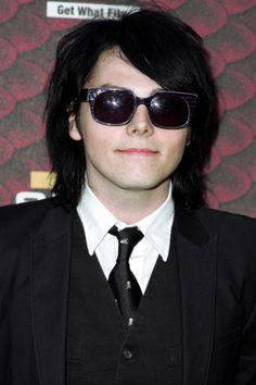 a man with black hair wearing sunglasses and a suit