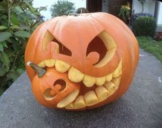 a carved pumpkin with an evil face on it