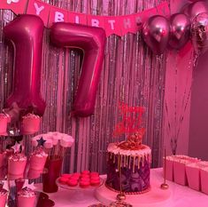 a birthday party with pink decorations and balloons