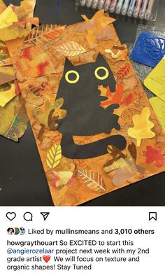 an image of a cat made out of paper and leaves on a table with markers