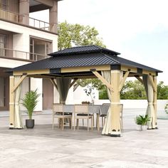 a wooden gazebo sitting on top of a cement floor next to a tall building