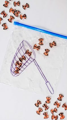 a bag filled with butterflies next to a blue plastic scoop full of orange monarch butterflies