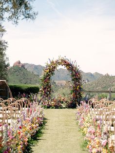 an outdoor ceremony setup with chairs and flowers