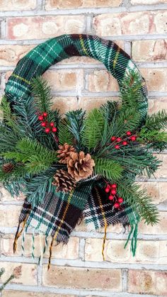 a wreath with pine cones and evergreen leaves