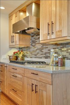 a kitchen with wooden cabinets and stainless steel range hood