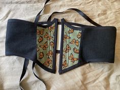 This beautiful monarch corset belt is a great accessory piece for any outfit! Complete with plastic boning in all seams and alongside the metal grommets to add support and structure but still allows for some flexibility. The lining is made of a sturdy canvas and the outer fabric is a cotton blend.  The corset measures 32 inch waist when fully closed and can be adjusted larger if desired. The front center of the corset is 8 inches in length. Womens Costumes, Corset Belt, Women's Costumes, Sewing Projects, Art Collection, Bathing Beauties, Cotton Blend, Purses And Bags, Sewing