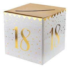 a white box with gold foil numbers on the front and bottom, decorated with confetti