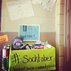 a green box filled with lots of items next to a sign that says scottober