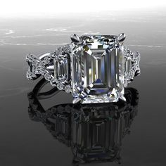 an emerald - cut diamond ring with three side stones on the shoulders and sidestones