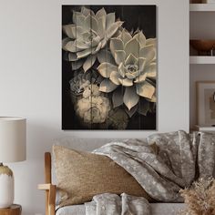 a living room scene with focus on the couch and flowers in vases mounted to the wall