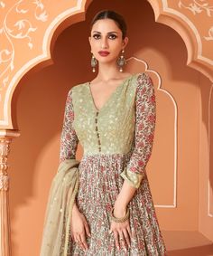 COLOR : Olive Green FABRIC : Gown - Pure Georgette, Dupatta - Net WORK : Resham Embroidery, Sequins, Digital Floral Print, Lace BorderOCCASION : Wedding, Reception, Mehendi, Engagement, Party Wear, Festival READY-TO-WEAR : No STITCHING : Available as semi-stitched fabric, can be stitched using standard size option (+$20). Note: There might be a slight color variation due to lighting and flash used during photoshoot. The bright shade seen is the best closer view of fabric's color. Semi-stitched Anarkali Gown With Resham Embroidery, Anarkali Gown With Resham Embroidery Semi-stitched, Semi-stitched Anarkali Dress With Floral Embroidery, Fitted Pista Green Anarkali Set With Intricate Embroidery, Semi-stitched Maxi Length Dupatta With Floral Embroidery, Fitted Anarkali Gown With Intricate Embroidery, Maxi Length Kurta With Intricate Embroidery For Reception, Maxi Length Embroidered Kurta For Reception, Embroidered Anarkali Georgette Dress