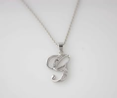 "Beautiful Initial Necklaces Solid Sterling Silver, perfect for anyone any age any occasions and everyday wear Great gift for that special someone or yourself. Item Specifications: Model # Letter G Metal Type: Sterling Silver Metal Stamp: 925 Shape: Letter G Finish: Rhodium Plated Style: Script Letter Size: 3/4 x 1/2inch ( approx 20x 13mm) Stone: Multi CZ Stone Chain: Sterling Silver Round Cable Chain 18\" * We only sell SOLID metals Stamp: 925 Sterling Silver. We do NOT Silver plate our Jewelry Letter G Necklace, G Necklace Letter, Initial Necklace G, G Letter Necklace, G Initial Necklace, G Initial, G Necklace, Initial G, Sliver Necklace