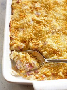 a white casserole dish filled with meat and cheese