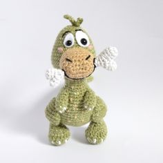 a crocheted stuffed animal with big eyes and wings on it's head