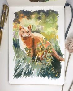 a watercolor painting of a cat sitting in the grass next to a brush and pen