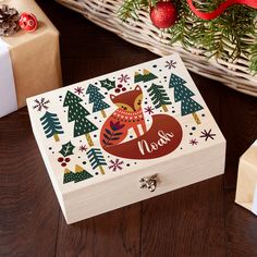 a wooden box with an image of a fox on it and christmas decorations around it