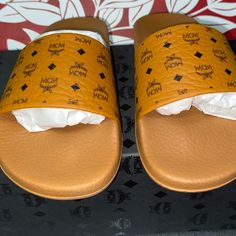 Brand New Never Worn Cognac Mcm Monogram Logo Women’s Slide Sandals Size 6,Super Cute! Designer Leather Slides For The Beach, Luxury Summer Sandals With Logo, Luxury Brown Slide Sandals, Designer Leather Sandals With Logo, Designer Leather Slides For Vacation, Logo Slip-on Sandals For Summer, Logo Open Toe Sandals For Summer, Designer Round Toe Sandals With Logo, Summer Slip-on Sandals With Logo