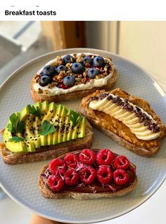 there are four different types of breads on the plate with berries, bananas and kiwi