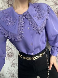 A vintage purple blouse, beautifully adorned with intricate embroidery, capturing the essence of 1970s fashion. This shirt is distinguished by its puritan collar, adding an elegant and modest touch. The rich purple fabric serves as a vibrant backdrop for the detailed embroidery, creating a striking contrast. Its design combines retro charm with sophistication, making it a unique and eye-catching garment. - Good vintage condition (small fabric wrinkle on the back, see photo) - TAG SIZE: No inform Vintage Collar Blouse For Party, Vintage Blouse With Collar For Party, Vintage Collared Blouse For Party, Purple Blouse For Spring Formal Occasion, Elegant Lavender Blouse For Party, Spring Purple Blouse With Collar, Elegant Lavender Party Blouse, Spring Purple Collared Blouse, Elegant Fall Blouse With Boho Collar