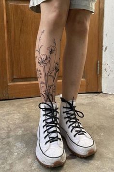 the legs and ankles of a person with tattoos on them