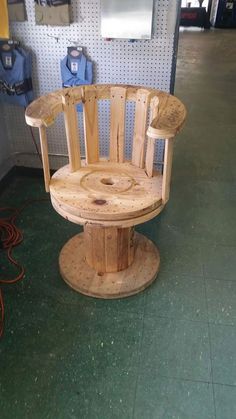 a wooden chair sitting on top of a table in a room next to a wall