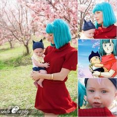 a woman with blue hair holding a baby