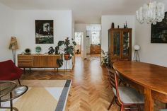 a dining room with wooden floors and white walls