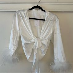 Brand New Never Worn Spring Night Out Tops With Feather Trim, Feather Trim Tops For Night Out In Spring, Chic Summer Tops With Feathers, Chic Feathered Tops For Fall, Long Sleeve Feathered Tops For Fall, Long Sleeve Tops With Feather Trim For Fall, Long Sleeve Feather Top For Fall, Elegant Feather Tops For Summer, Chic Spring Tops With Feather Trim