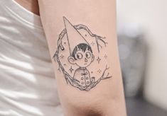 a woman's arm with a tattoo on it that has a drawing of a boy