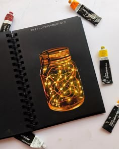 a notebook with lights in a jar on it