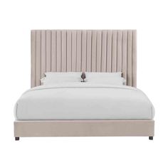 a bed with a beige headboard and two pillows on top of it, against a white background