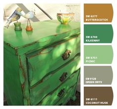 an old dresser painted in green and brown