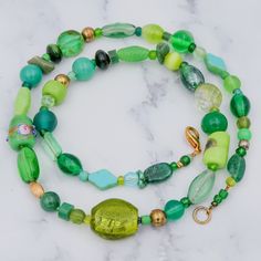 This vintage beaded necklace features various vintage and handmade glass beads in different shades of green and gold, some genuine turquoise beads, an Italian wedding cake bead and one large foil glass bead. This necklace measures 22 inches in length, and the largest bead measures 17mm. This necklace is in excellent vintage condition with light wear. Green Glass Round Bead Jewelry, Vintage Green Glass Beaded Necklaces, Green Beaded Necklaces With Colorful Oval Beads, Green Vintage Glass Beaded Necklaces, Green Beaded Necklace With Colorful Oval Beads, Green Oval Beaded Necklaces For Gifts, Green Oval Beads Necklaces For Gifts, Green Oval Spacer Beads Jewelry, Green Glass Beaded Bracelets With Round Beads