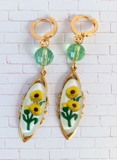 Fascinating vintage Chrysanthemum relief Lucite cabochons mounted on high-end sturdy stamped brass pieces with lustrous faceted beads for a little added shimmer. Classic versatile earrings that will complement so many wardrobe options. If these caught your eye, you may also like the Bluebell https://etsy.me/35X8fJg or the Petunia https://etsy.me/3i9g6Ge These make a special gift too! Thanks for looking! Vintage Collection Dangle Jewelry With Matching Earrings, Vintage Brass Clip-on Earrings For Gift, Vintage Brass Drop Earrings, Green Vintage Flower Earrings For Gift, Green Vintage Flower Earrings As Gift, Vintage Cabochon Dangle Earrings, Vintage Czech Glass Matching Earrings, Vintage Cabochon Metal Earrings, Flower Shaped Brass Jewelry With Matching Earrings