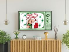 an old fashioned television with a santa clause on it's screen and christmas decorations