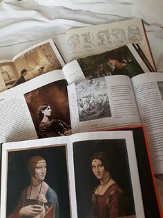 an open book with pictures of women and men in them on top of a bed