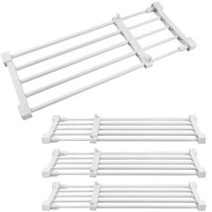 four white clothes drying racks and one rack with three bars on each side, all in different sizes