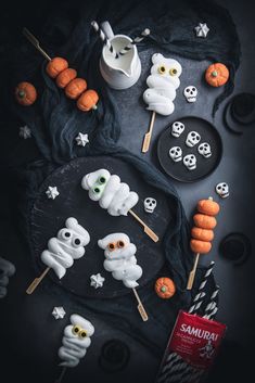 halloween treats are arranged on a black table