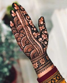 a woman's hand with henna on it