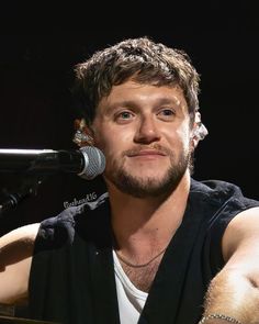 a man sitting in front of a microphone