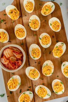 an overhead view of deviled eggs on a cutting board