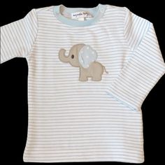 Your Little One Will Be Snuggly Warm While They Play All Day In This Applique Collection From Magnolia Baby. Your Baby Will Feel Comfy And Cozy Wrapped Up In The Super-Soft Pima Cotton. The All Over Print Features Blue Stripe Ls Tee With An Embroidered Baby Elephant. Features Embroidered Baby Elephant Long Sleeve Tee 100% Pima Cotton Machine Washable White Long Sleeve T-shirt For Playtime, Cute Unisex Long Sleeve T-shirt, White Unisex Long Sleeve Top, Playful White Long Sleeve T-shirt, Unisex White Long Sleeve T-shirt, Cute Light Blue Tops For Playtime, Cute Unisex White Shirt, White Crew Neck Shirt For Playtime, Elephant Applique