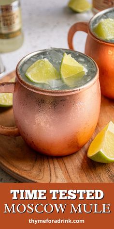 two moscow mules with lime wedges on a wooden tray and the text time tested moscow mule