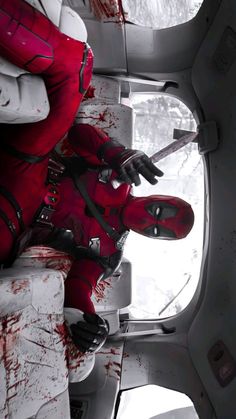 a dead body in a red suit with blood all over it