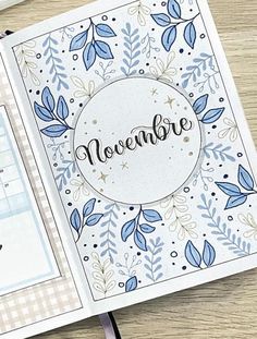 an open planner book with the word november written in cursive writing on it