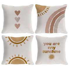 four pillows with different designs on them, one is white and the other has gold