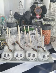 there are many halloween treats on the table with candies in bags and marshmallows