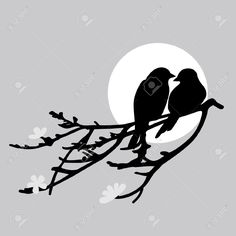 two birds sitting on a branch in front of the moon