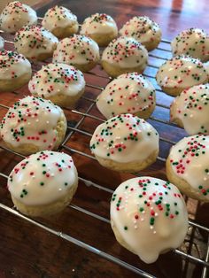 there are many frosted donuts that are on the cooling rack and ready to be eaten